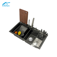 Smart multifunction black kitchen sink with dual handmade bowls, knife holder, cutting board rack, soap dispenser & more – ideal for modern homes.
